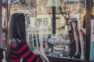 Customer of a small business window shopping