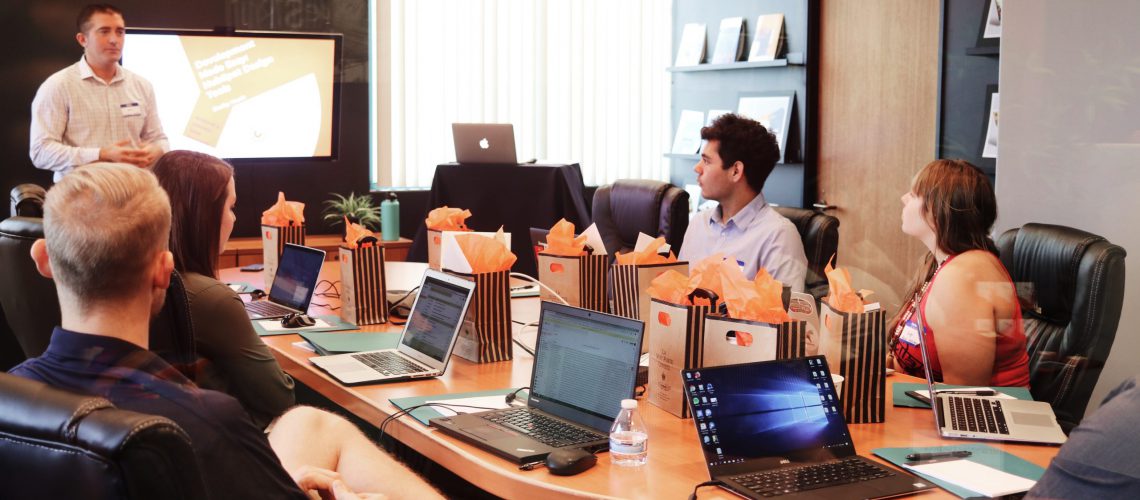 Marketing team sitting at a conference table.